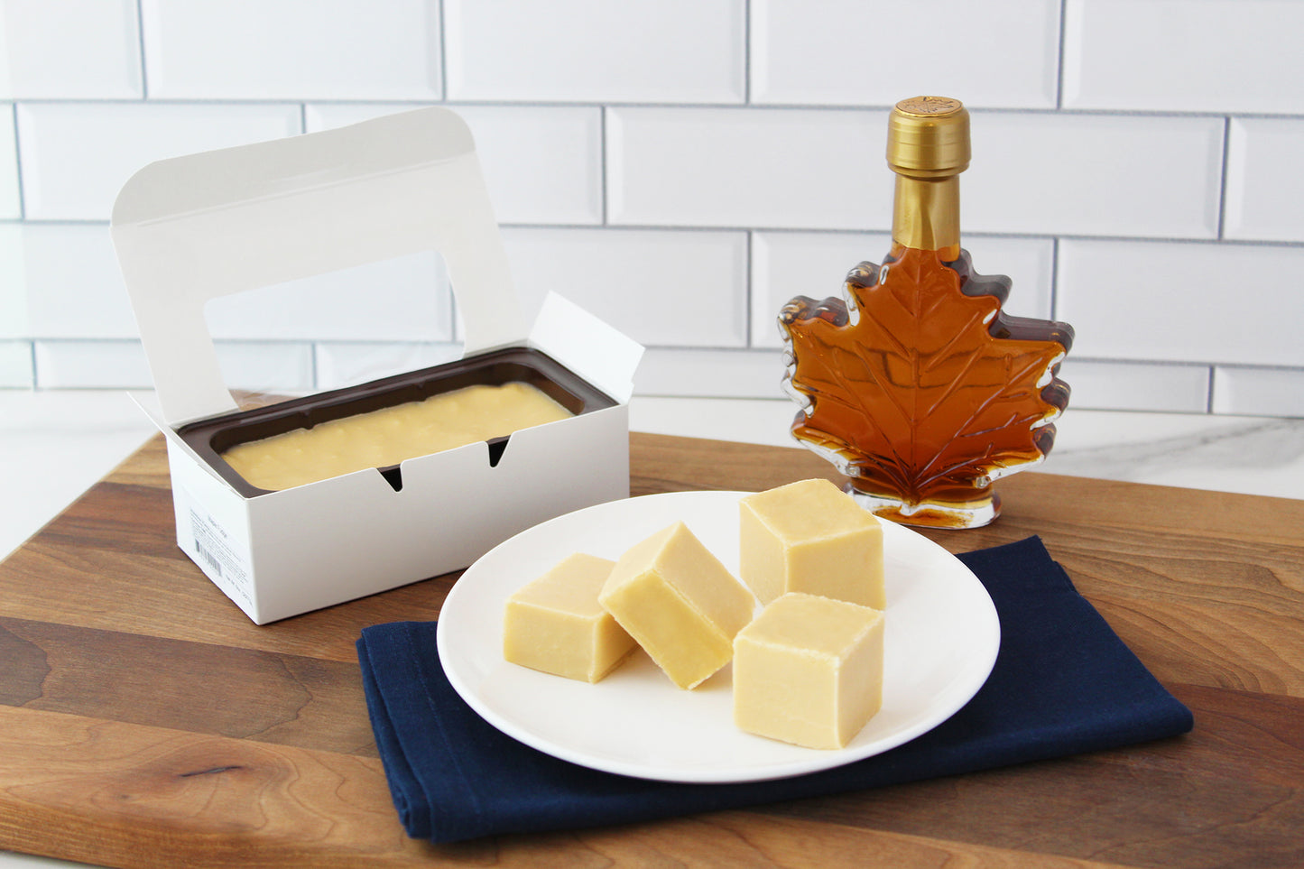 Maple fudge and maple syrup on countertop